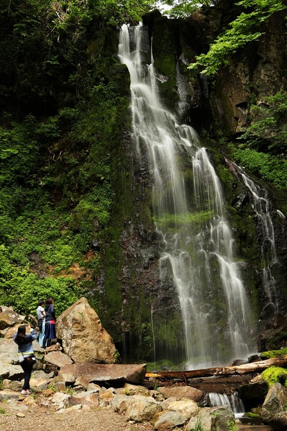 写真: 滝を見上げ、マイナスイオンを浴びる滝ガール