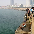 写真: 青島　大桟橋から網を打つ人