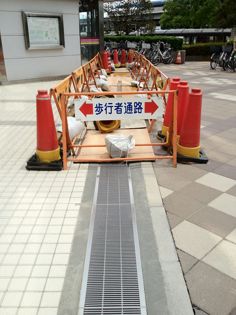 写真: 液状化で陥没したグレーチングの復旧工事 検見川浜駅前