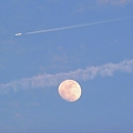 月にかかる飛行機雲