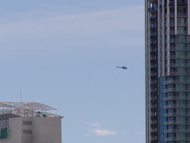 The Strip View -　Chopper flys near Palms